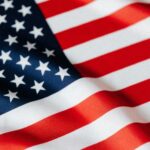 From above of closeup flattering national flag of USA with white and red stripes and stars on blue background